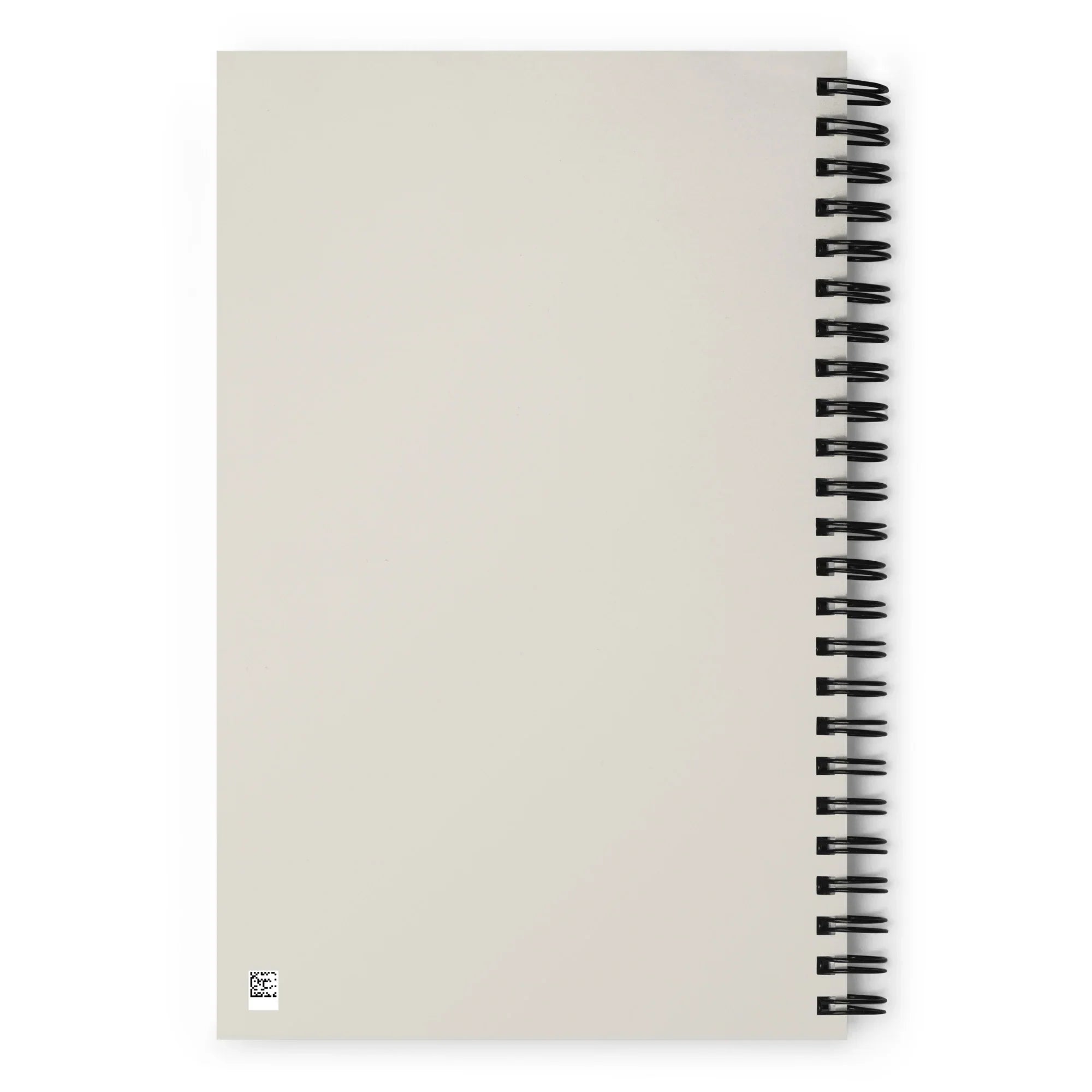 Carnet à spirale à couverture beige uni, dos visible, style minimaliste.