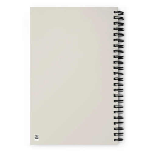 Carnet à spirale à couverture beige uni, dos visible, style minimaliste.